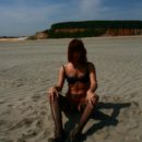 Russian redhead girl posing in stockings on the sand