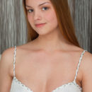 The allure and romance of a powerfully seductive woman, Ledina strips her dreamy white lingerie dress, spreading her legs to reveal her delectable, pink pussy on top of the bed