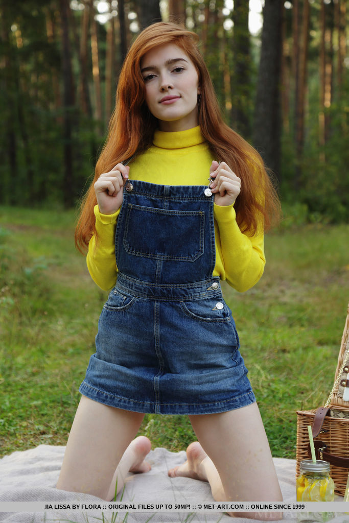 Redhead Jia Lissa strips outdoors as she displays her trimmed pussy.