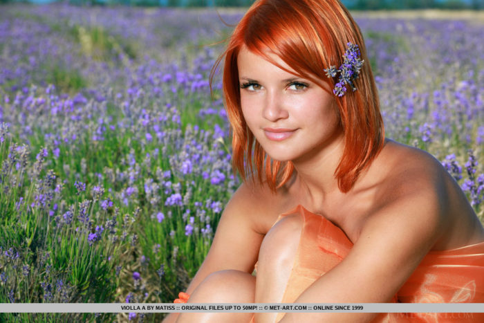 Redhead Violla A bares her sexy, tanned body and smooth pussy in the meadows.