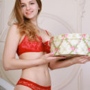 Veronika Mink strips her sexy, red lingerie as she bares her sweet pussy.