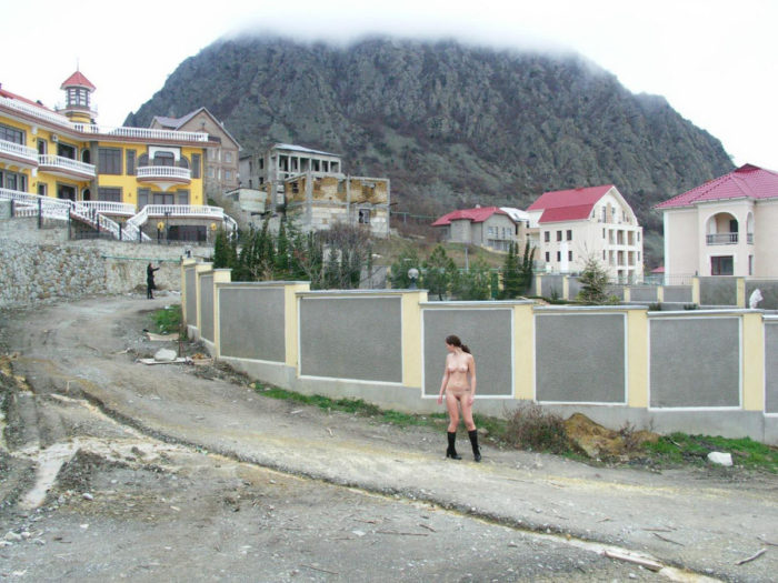 A girl in boots in a mountain village