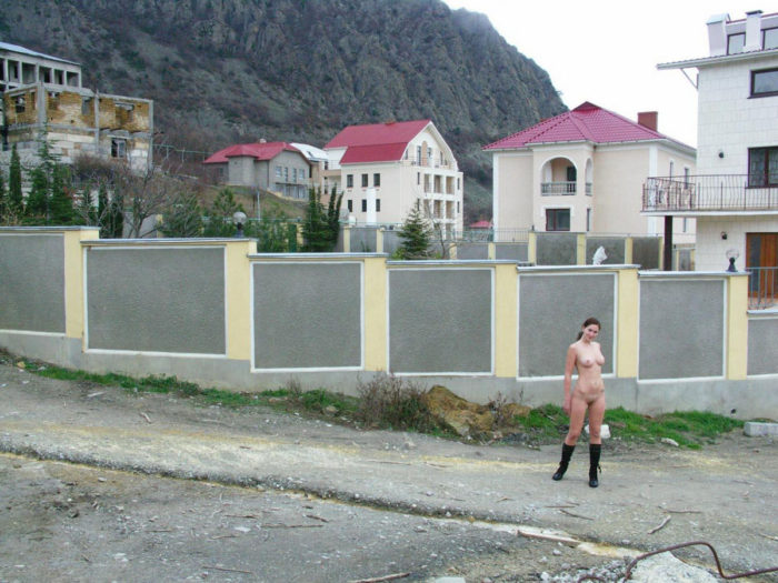 A girl in boots in a mountain village