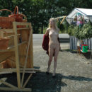 Absolutely naked blonde at road market