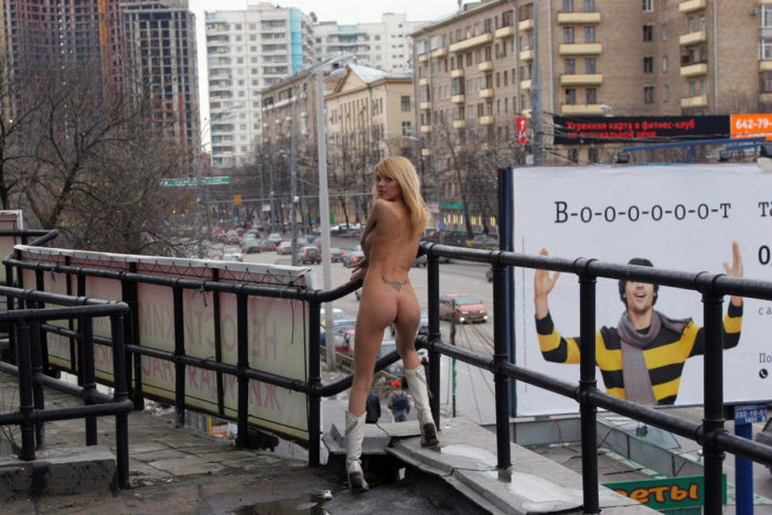 Blonde in white boots spreads legs on the streets