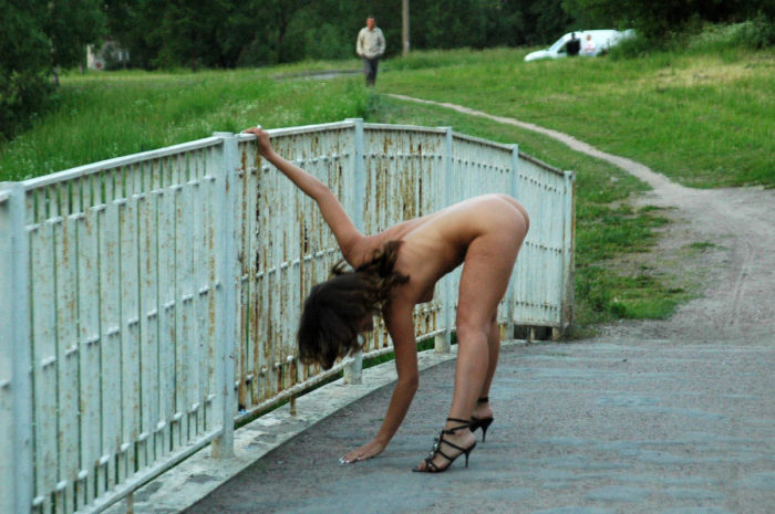 Girl in black shoes on a small bridge
