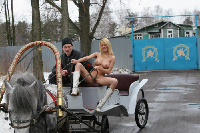 Lovely blonde Uliana A is riding on a horse cart (naked)