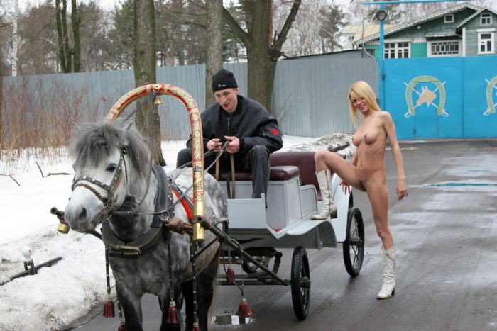 Lovely blonde Uliana A is riding on a horse cart (naked)