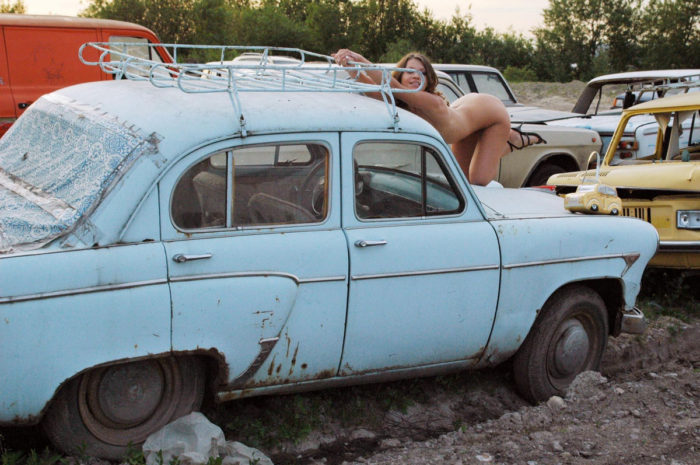 Naked girl Oksana E in the dump of old cars