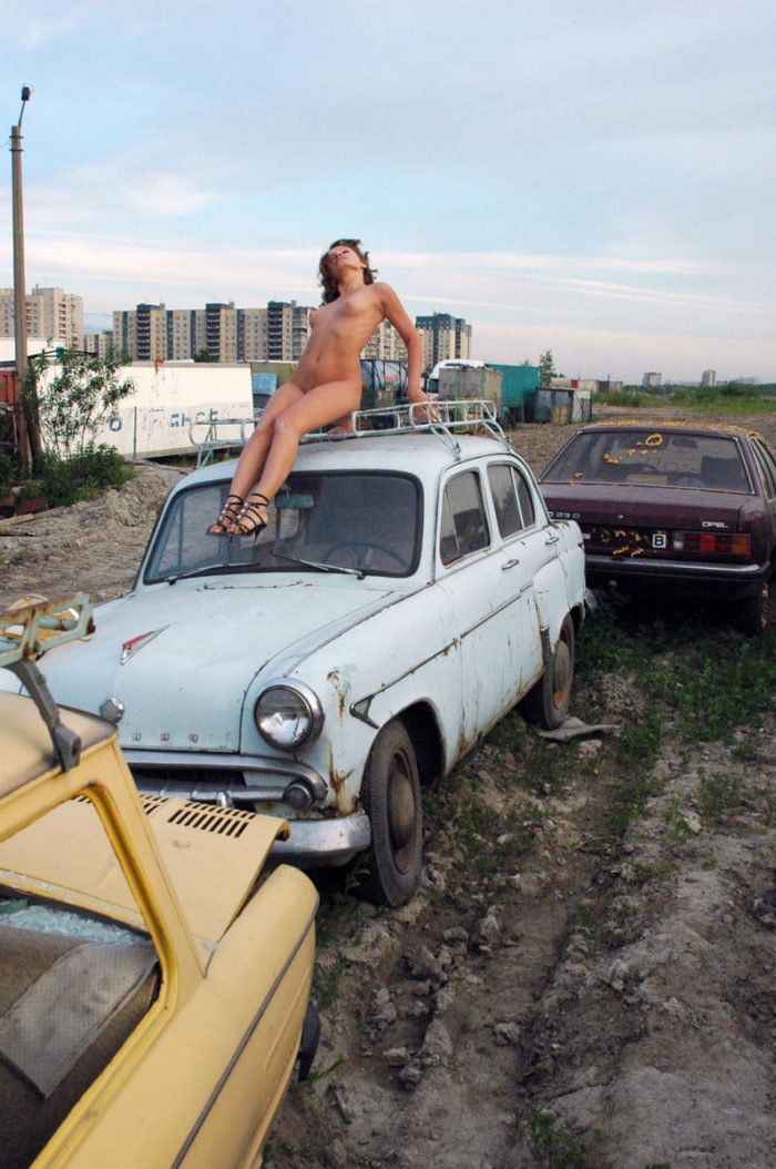 Naked girl Oksana E in the dump of old cars