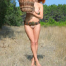 Redhead Violla A bares her sexy, naked body and big tits outdoors.
