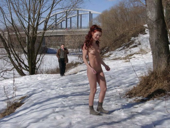 Redheaded girl Sabiria with a stranger at winter park