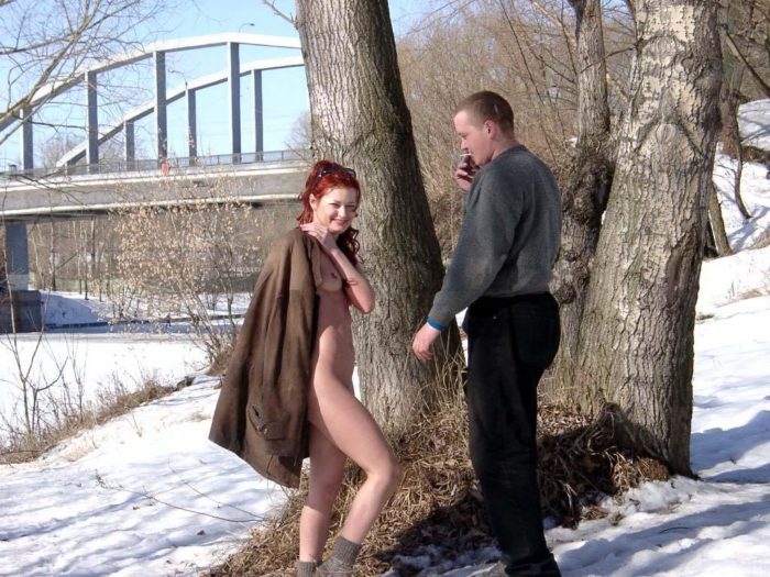 Redheaded girl Sabiria with a stranger at winter park