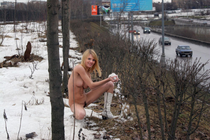 Shameless blonde with hairy pussy posing near busy road