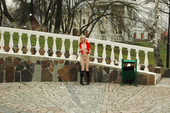 Skinny blonde Julia G in black boots and red scarf