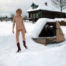 Smiling blonde pulls water from the well