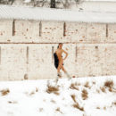 Sporty brunette walks naked during snowstorm