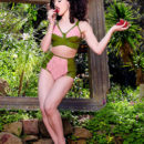 Curly brunette Mosh posing with strawberries