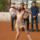 Totally nude damsel on the football ground with strangers