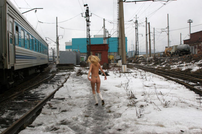 Blonde Uliana A with no clothes posing on railroad