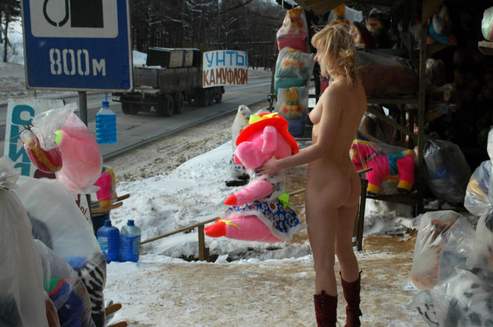 Blonde without clothes posing in the roadside market