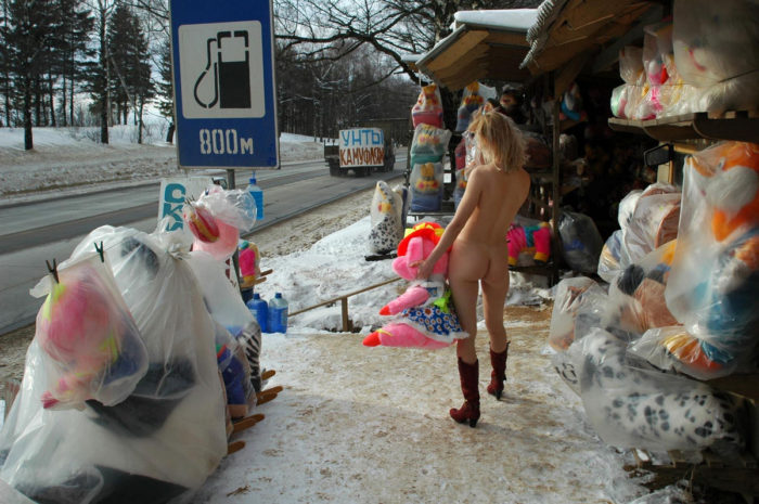 Blonde without clothes posing in the roadside market