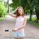 Dennie strips on the couch baring her petite body and unshaven pussy.