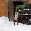 Girl in red boots in the museum of trains