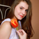 Lauren Swift strips on the bed baring her nubile body and smooth pussy on the bed.