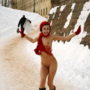 Naked girl in a red beret in a winter park