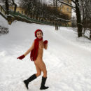 Naked girl in a red beret in a winter park