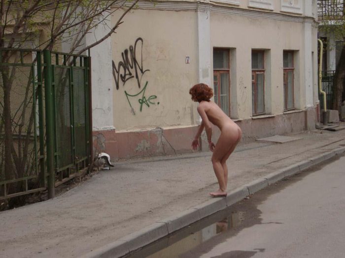 Naked redhead with sporty body on the streets