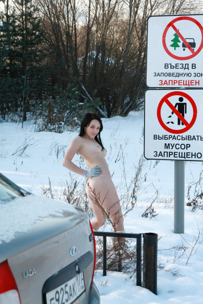 Naked teen brunette shows her body at snowy forest