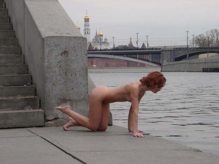 Red-haired girl posing in the center of Moscow