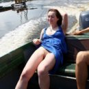 Smiling girl Tamara D shows hairy pussy on small boat