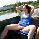 Smiling girl Tamara D shows hairy pussy on small boat