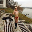 Teen blonde removes red panties by the river