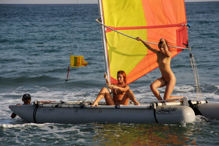 Two bare girls on various sea transports
