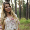 Kira takes off her top and panties and starts masturbating in the middle of the woods