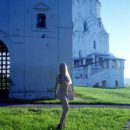 Russian blonde Elza with slender body walks at park