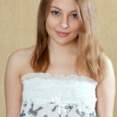 Alluring Nikia A displays her amazing body and smooth pussy on the floor.