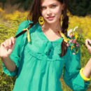 Liza J flaunts her delectable unshaven labia with a warm, engaging smile outdoors.