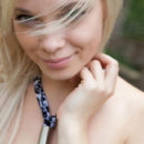 Lovely blonde Feeona A posing outdoors with protruding nipples