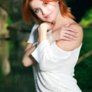 Redhead Violla A strips by the river baring her sexy body and sweet pussy.