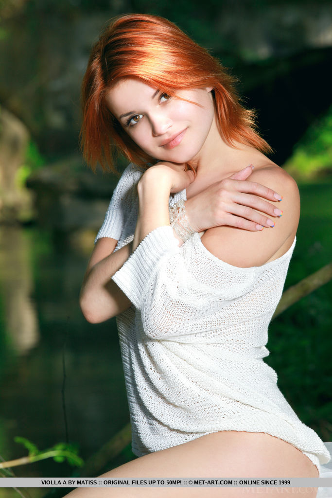 Redhead Violla A strips by the river baring her sexy body and sweet pussy.