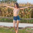 A gorgeous Sunshine A enjoying the cool wind in the countryside, confidently posing and showcasing her slender body with delicious puffy nipples and long legs.