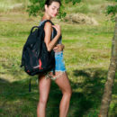 Georgia s charming smile and playful poses showcasing her slender physique amidst the green outdoors