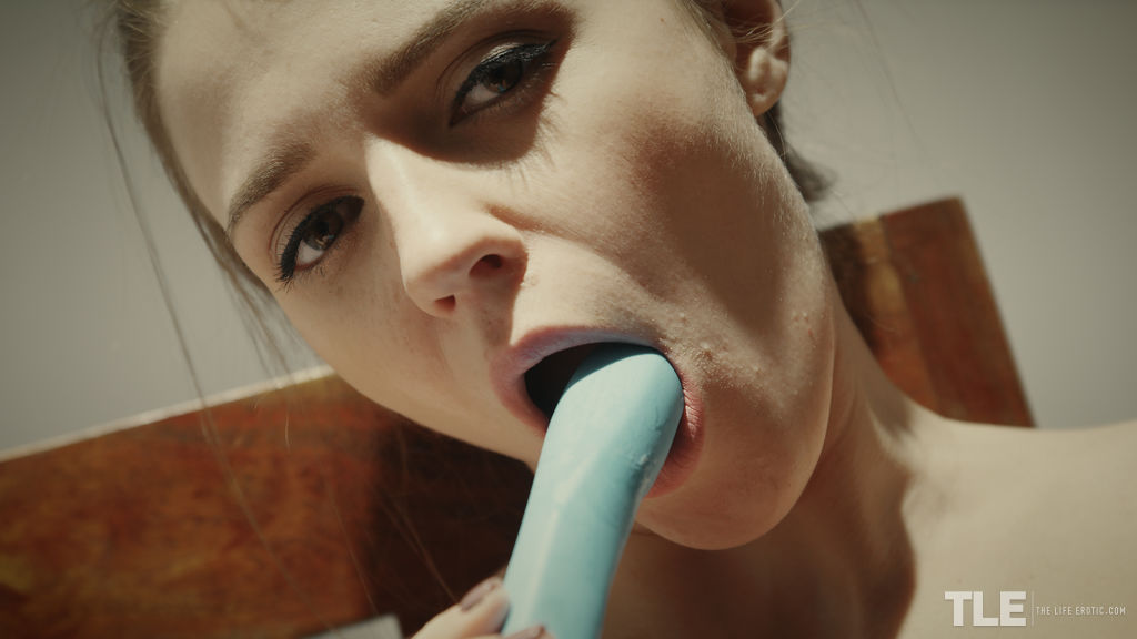 Kalisy satisfies her shaved snatch with a blue dildo