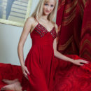 Sweet blonde Zemira A on red sofa