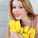 After stripping off every bit of her clothing, a sweet-smiling Erica B spreads her legs wide open, showcasing her magnificently puffy breasts, moist pussy, and smooth legs.